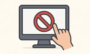 Monitor z symbolem zakazu i palcem wskazującym, symbolizującym blokowanie stron internetowych.