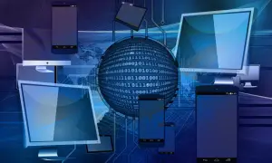 Cyfrowa sieć z komputerami i telefonami, symbolizująca potrzebę wiedzy, jak usunąć wirusa z komputera, by chronić dane.