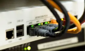 Złącza Ethernet w urządzeniu sieciowym, zielone diody sygnalizują połączenie. Czy kabel Ethernet ma znaczenie? Tak, dla stabilności sieci.