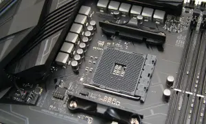 Szukasz odpowiedzi, jaką płytę główną wybrać? Zbliżenie na gniazdo procesora AM4 i sekcję zasilania płyty głównej ASUS ROG.