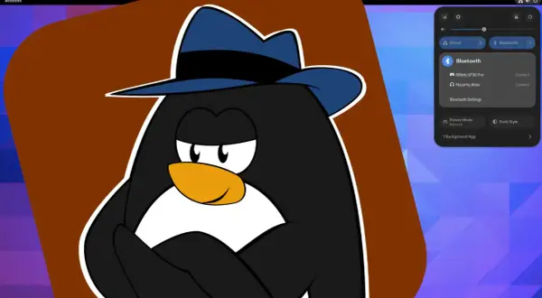 Pingwin w fedorze na tle pulpitu Fedora 37, z widocznym panelem ustawień Bluetooth.