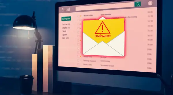 Komputer wyświetla ostrzeżenie o złośliwym oprogramowaniu w skrzynce e-mail. To może być przykład, co to trojan - ukryty w pozornie niewinnym pliku.